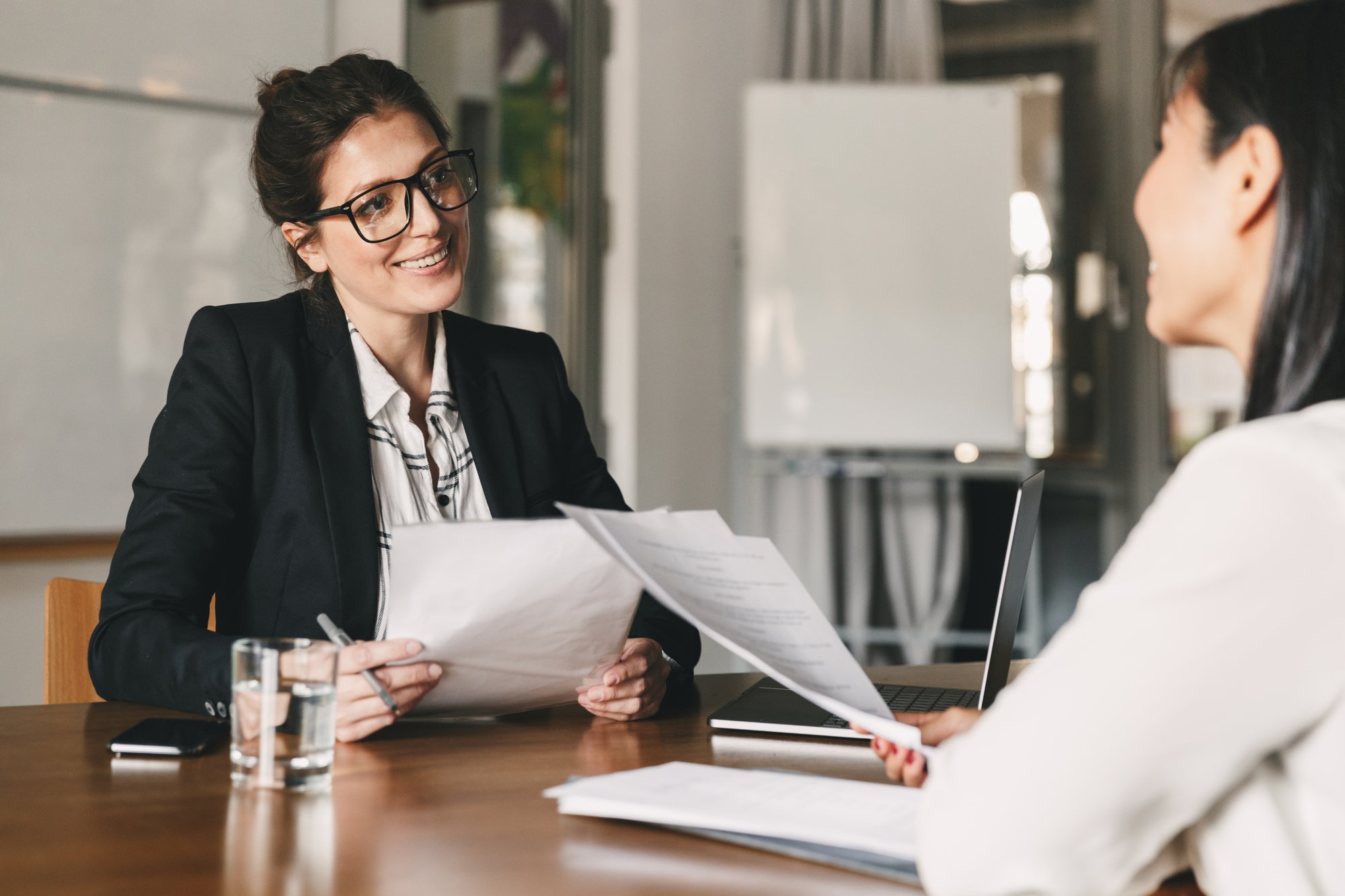 portrait-of-smiling-businesswoman-holding-resume-a-2023-11-27-04-57-05-utc
